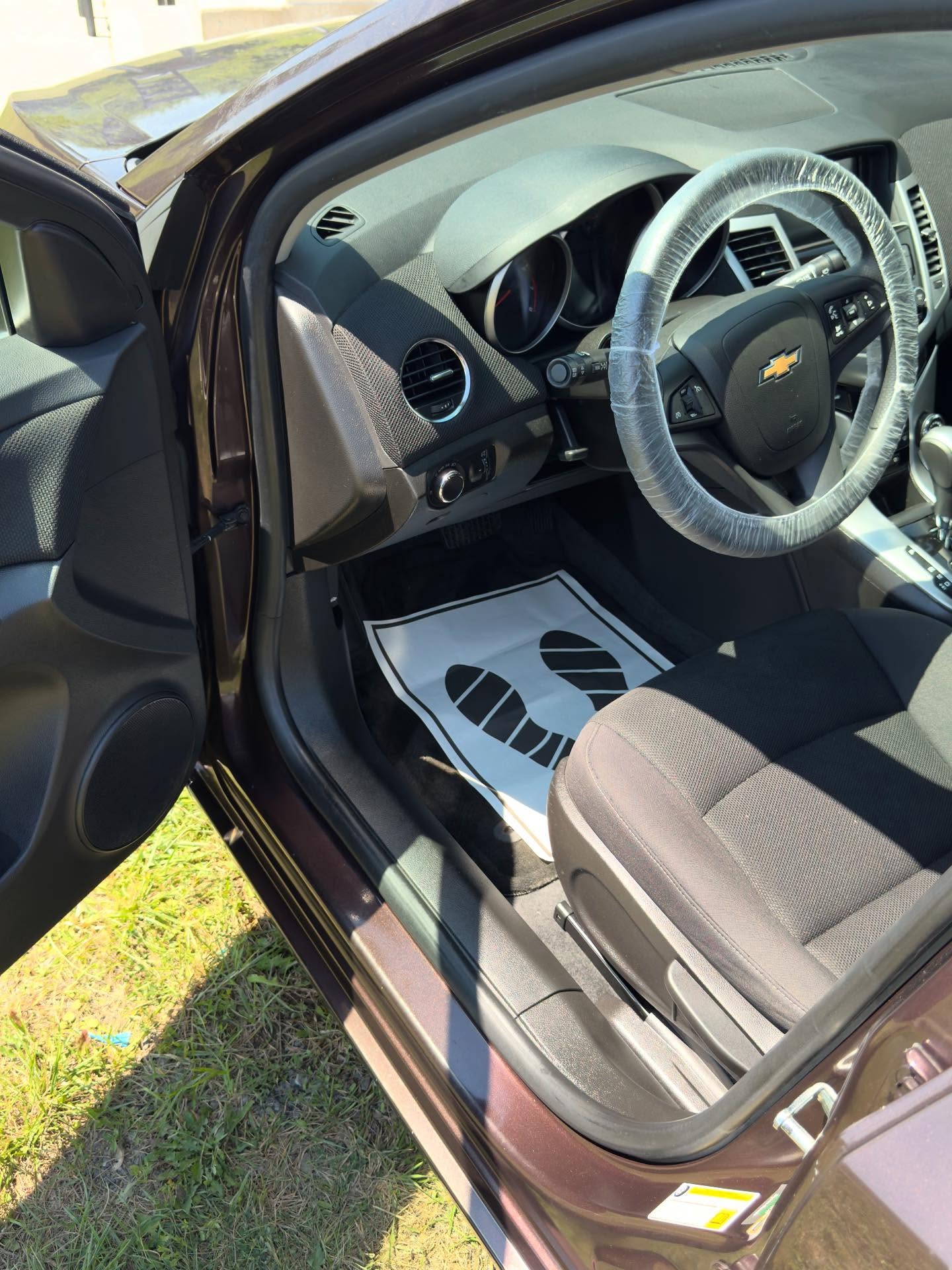 RSK Auto Detailing — Chevy Cruze interior after detailing, steering wheel wrapped and floor protected