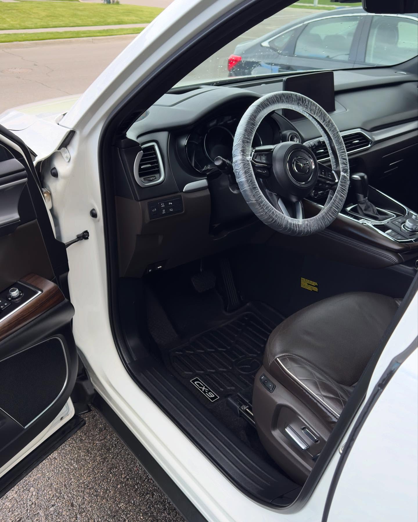 RSK Auto Detailing — Mazda CX-9 interior after detailing, clean black mats and wrapped wheel