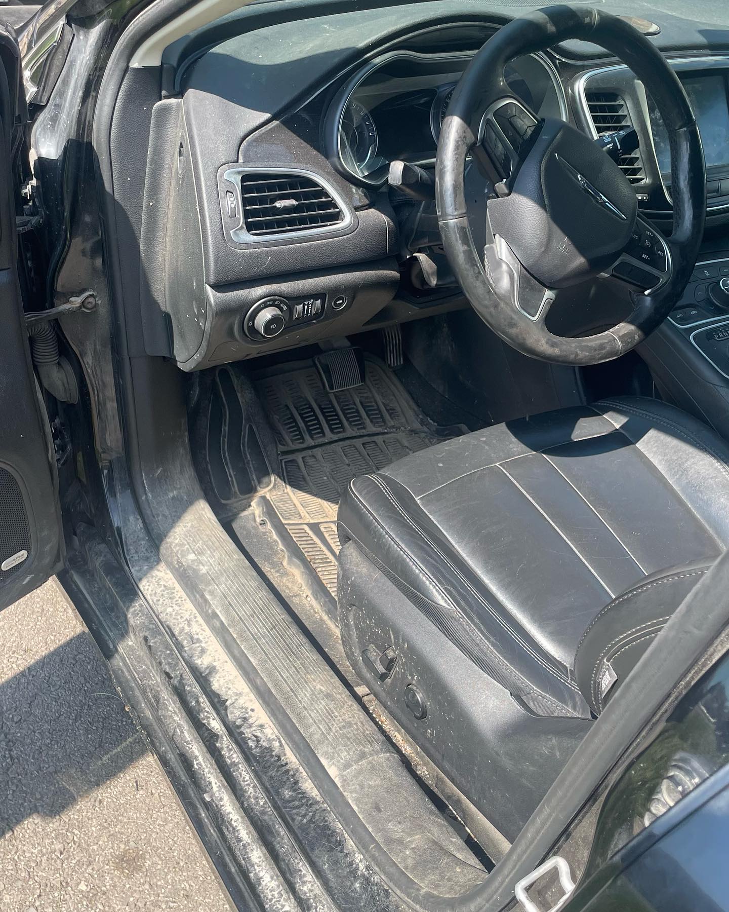 RSK Auto Detailing — Chrysler 200 interior before detailing, dirty mats and dusty surfaces